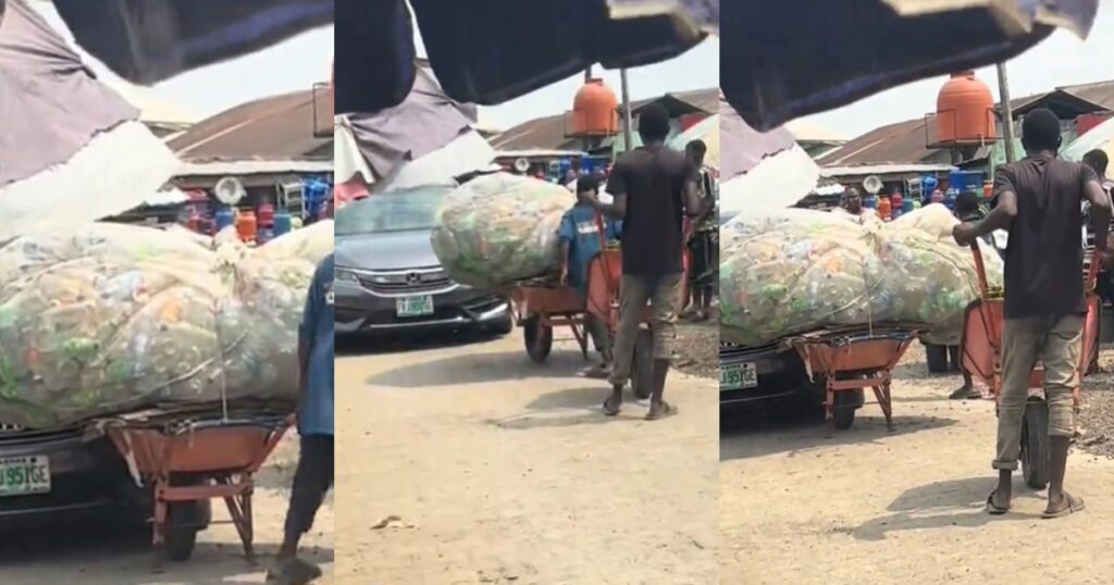 wheelbarrow pusher bl0cks a car on a roadway at a local market (VIDEO)